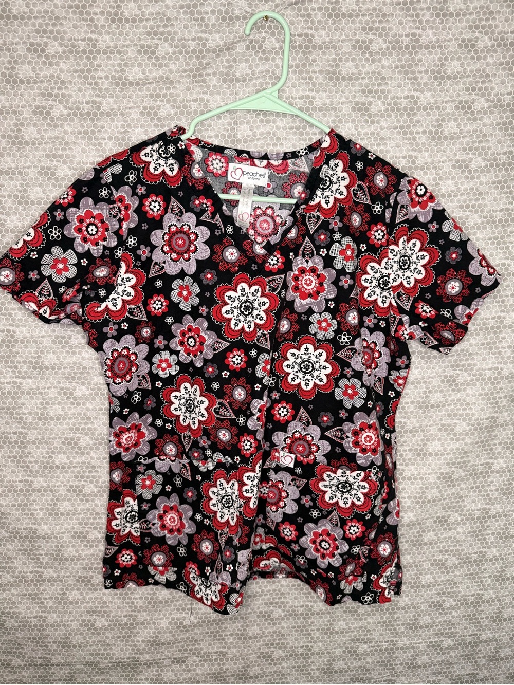 Peaches Uniforms scrub top with red, white, and gray floral print Large